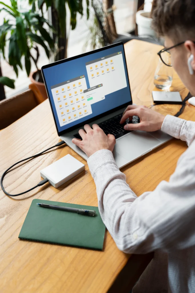 young man typing laptop desk